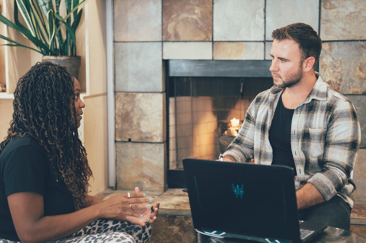 Nick working through a problem on his laptop with a client during a live session