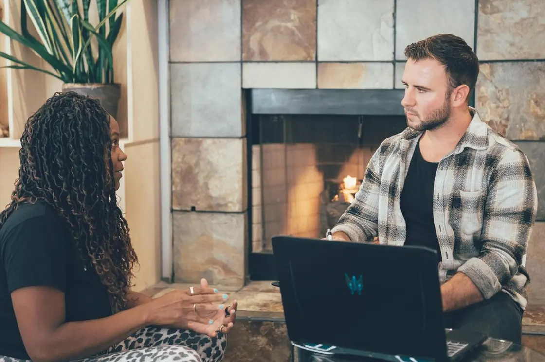 Nick working through a problem on his laptop with a client during a live session